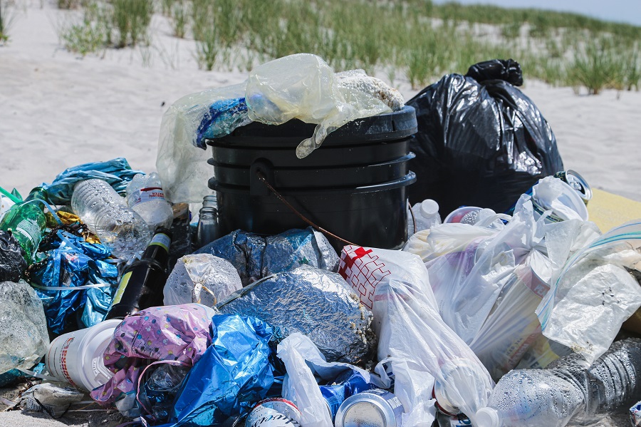 A lot of garbage bags piled on the ground A lot of garbage bags piled on the ground